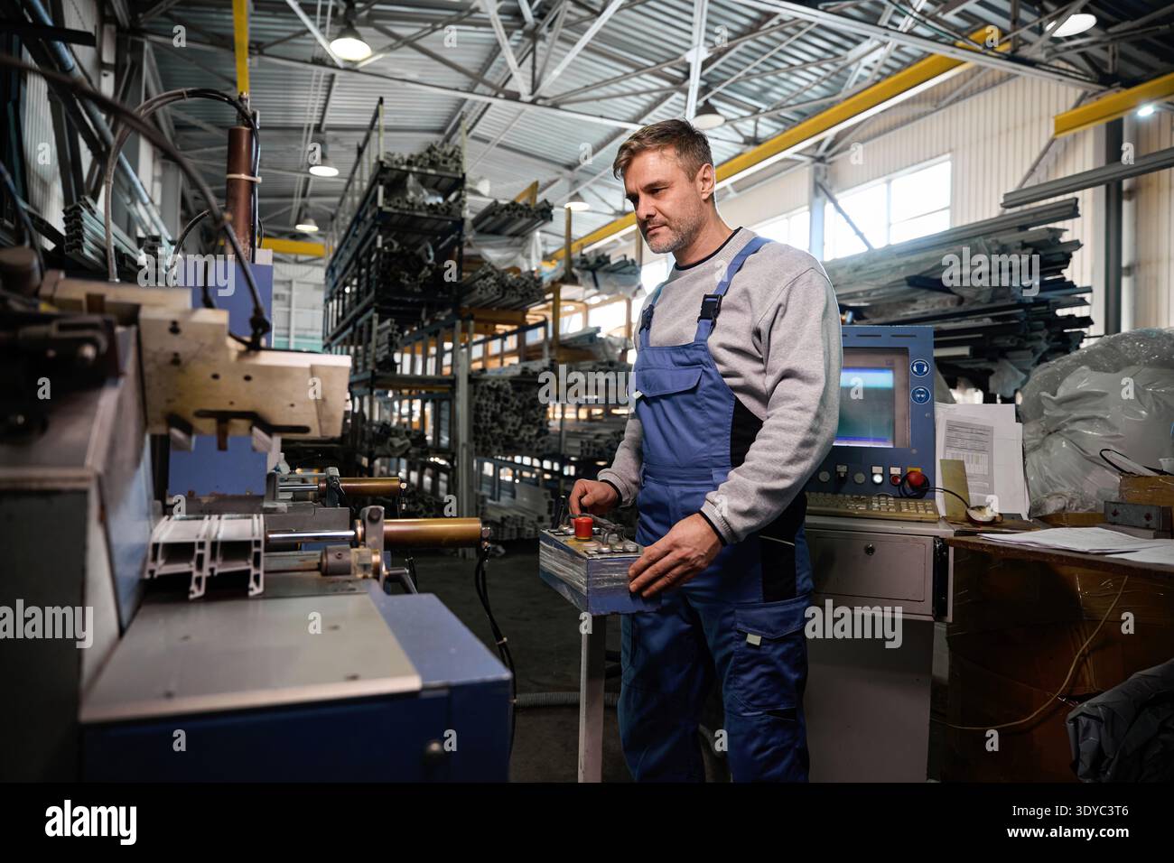 Professional production workers in coverall working with different PVC windows Stock Photo