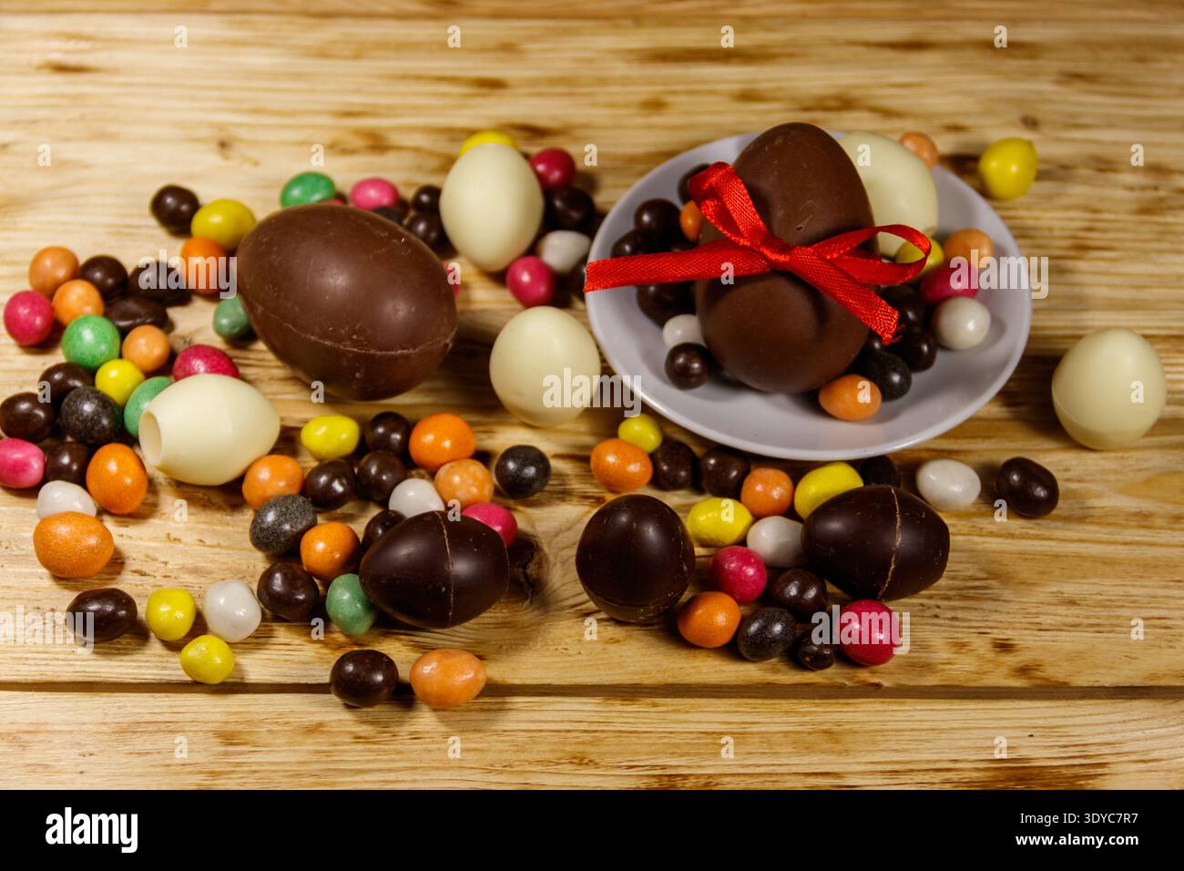 Easter composition with chocolate eggs on wooden background Stock Photo