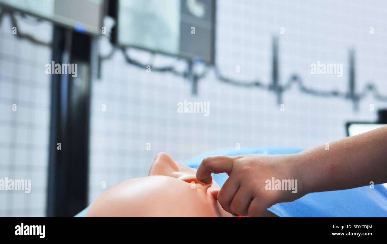 Healthcare student learning CPR and clinical procedures using a medical ...