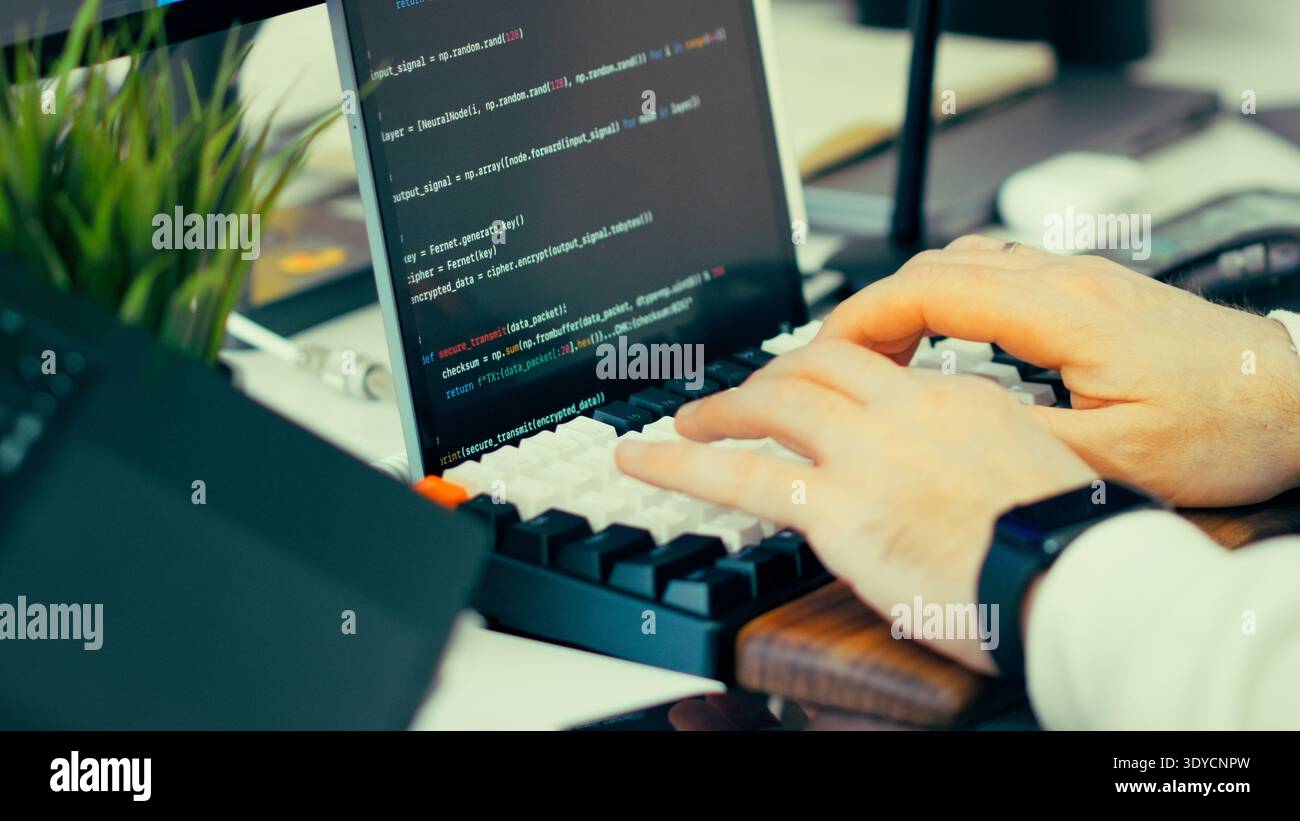 Programmer typing keyboard laptop screen source code. Software development workflow computer workstation coding environment. Digital engineering proce Stock Photo