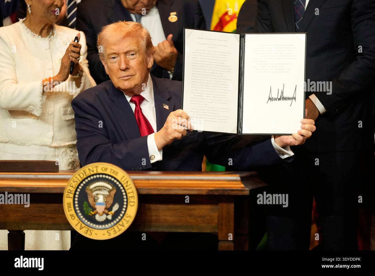 President Donald Trump signs a proclamation at the Shield of the ...