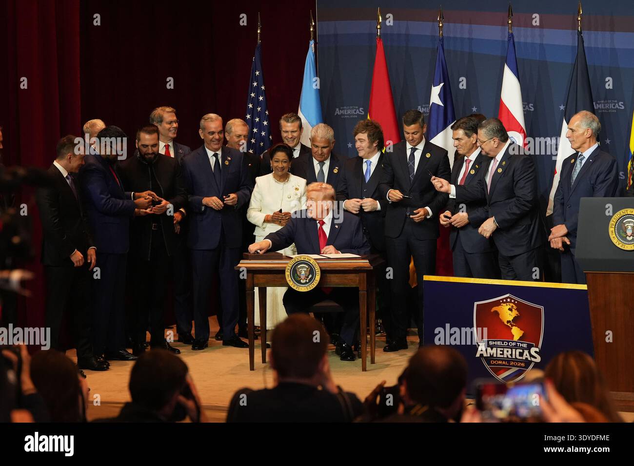 President Donald Trump hands out pens after signing a proclamation ...