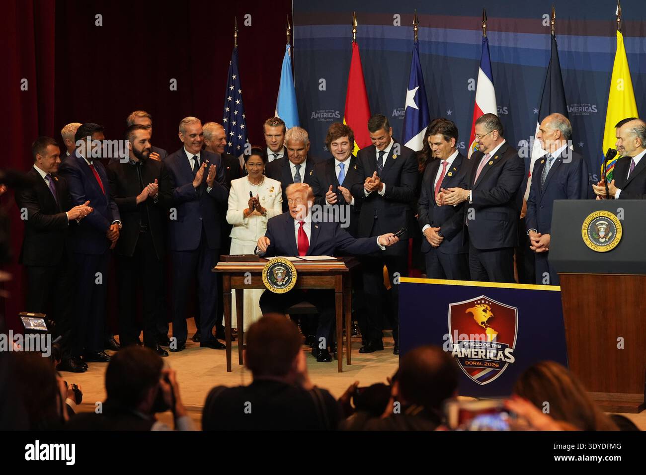 President Donald Trump hands out pens after signing a proclamation ...