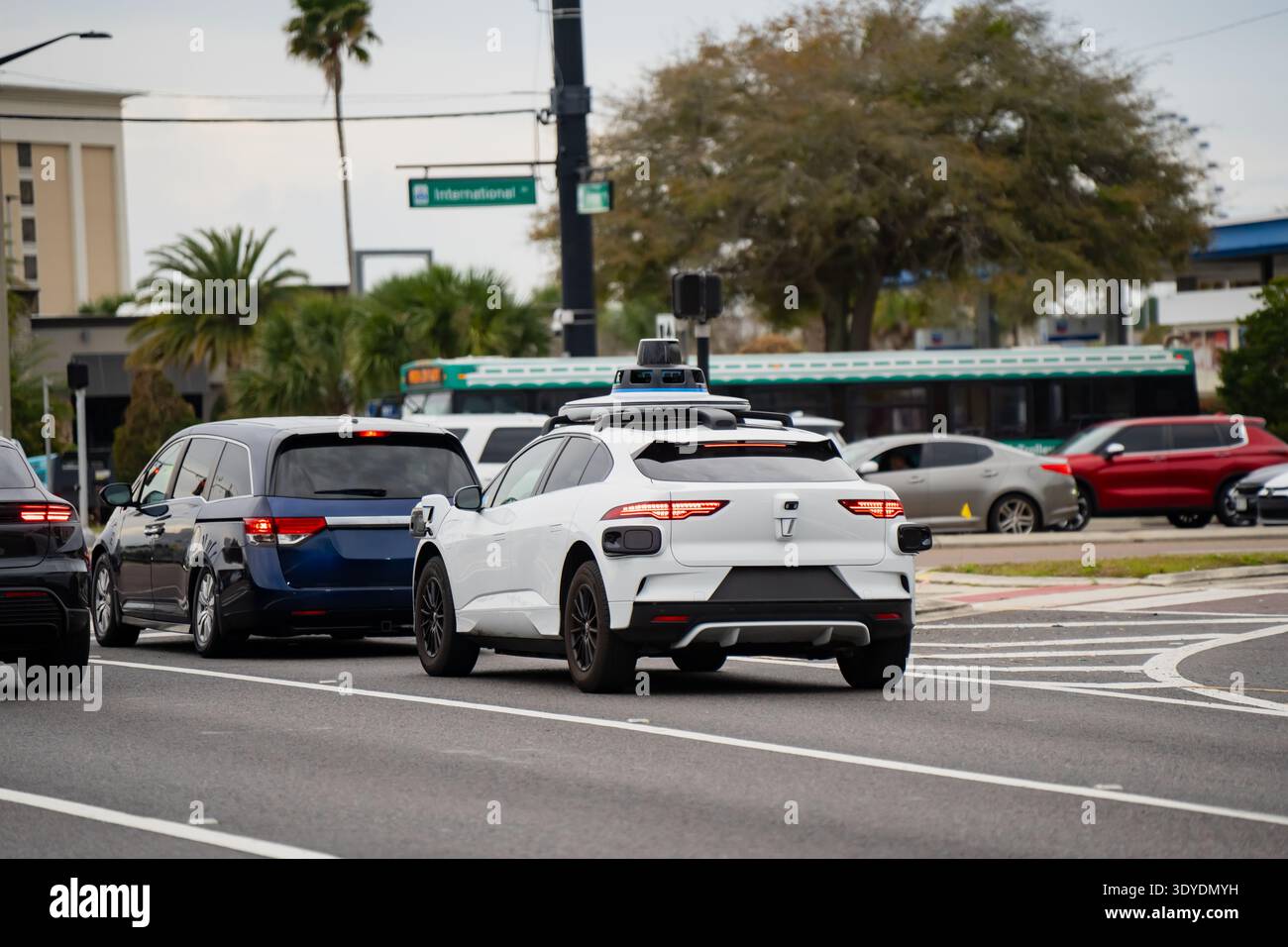 Self driving electric vehicle with visible sensor array moving among ...