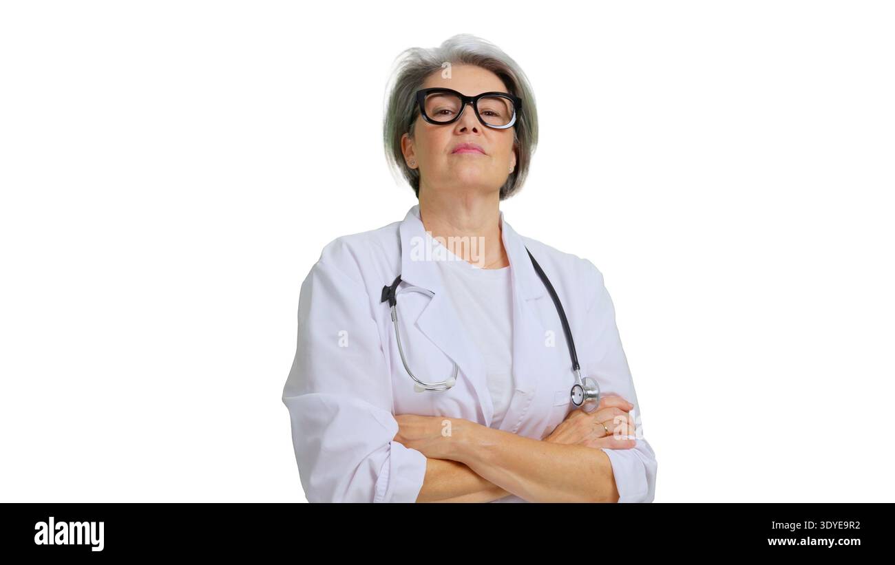 Mature doctor with stethoscope standing with arms crossed Stock Photo