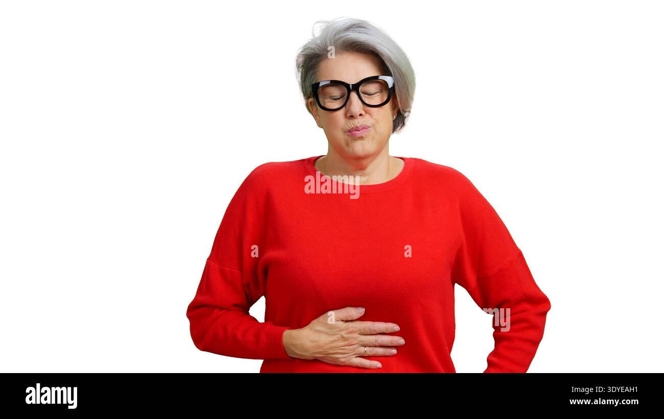 Senior woman suffering from stomach ache and indigestion Stock Photo