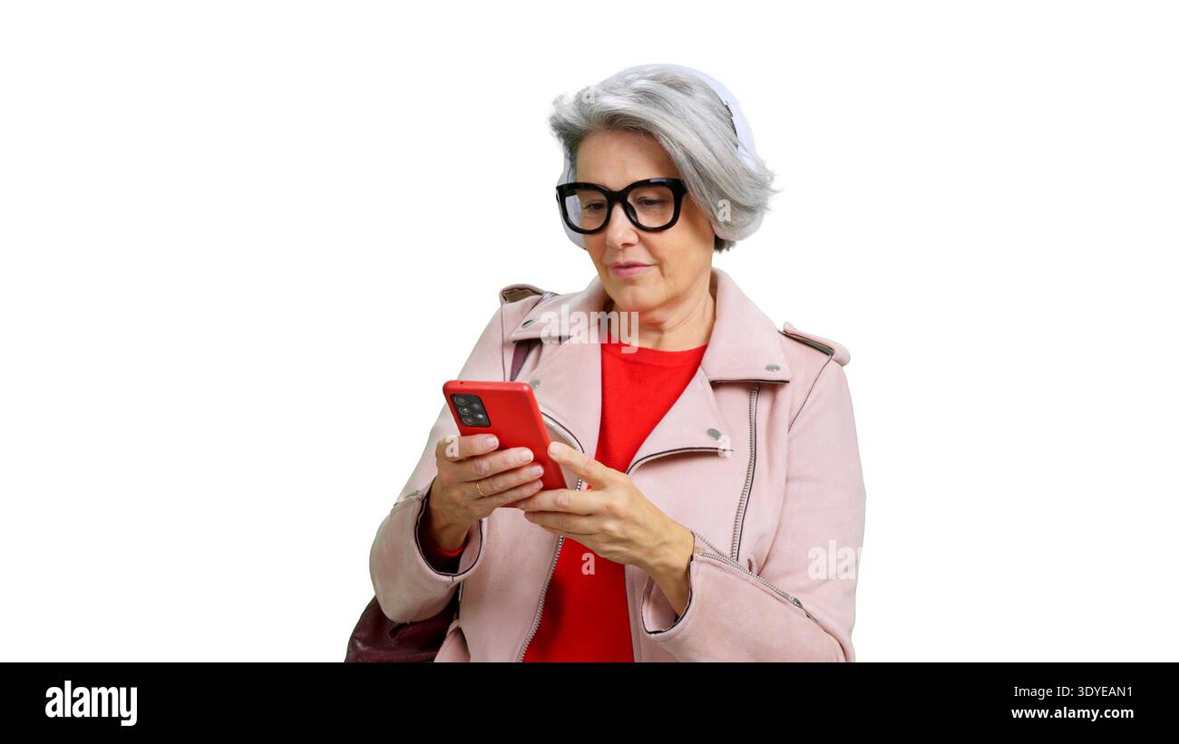 Senior woman using phone and listening music Stock Photo