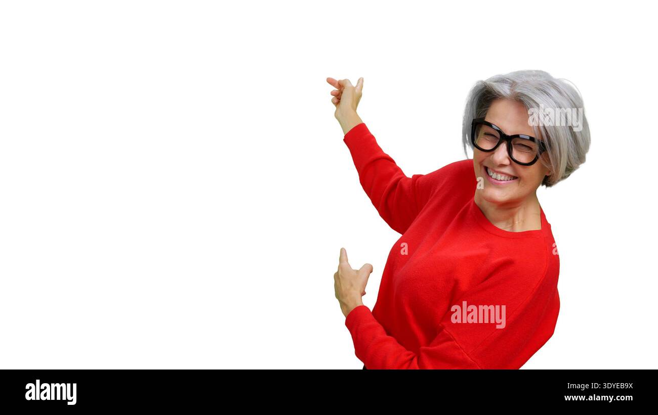 Senior woman smiling pointing up and away with both hands Stock Photo
