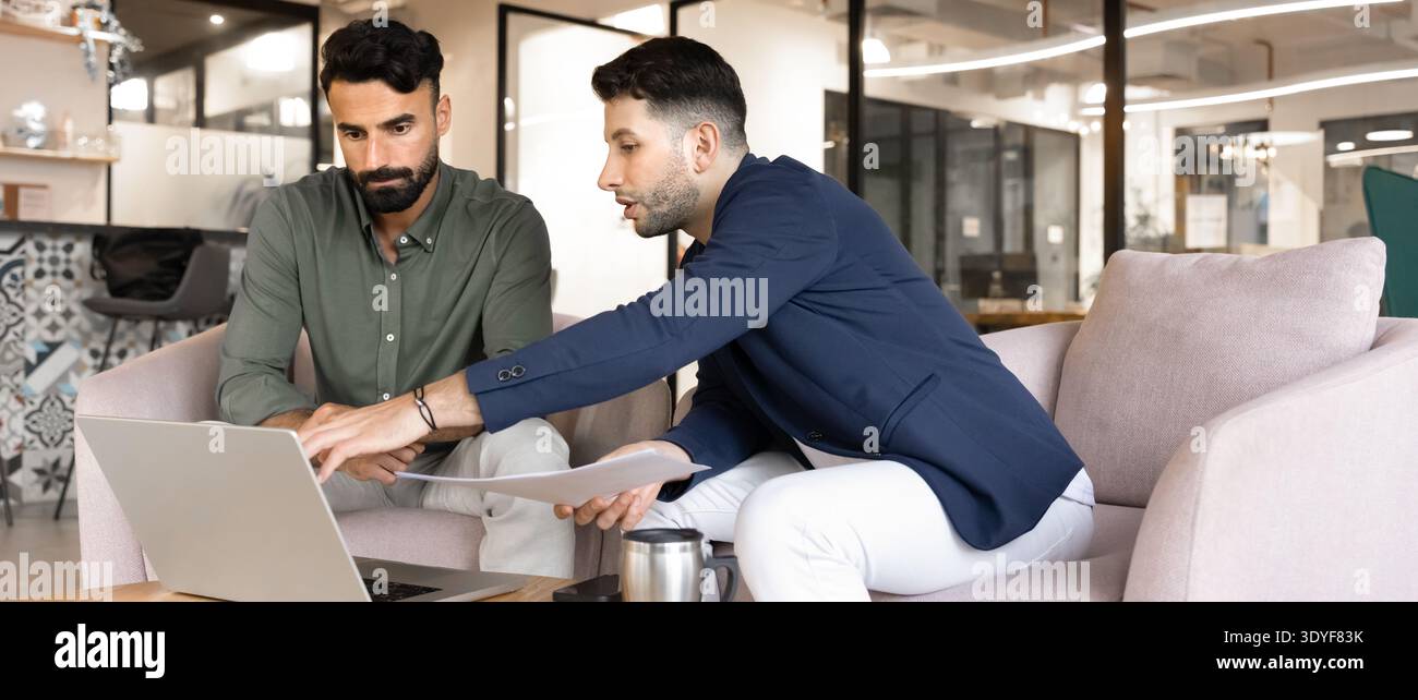 Middle Eastern businessmen engaged in business discussion in office Stock Photo