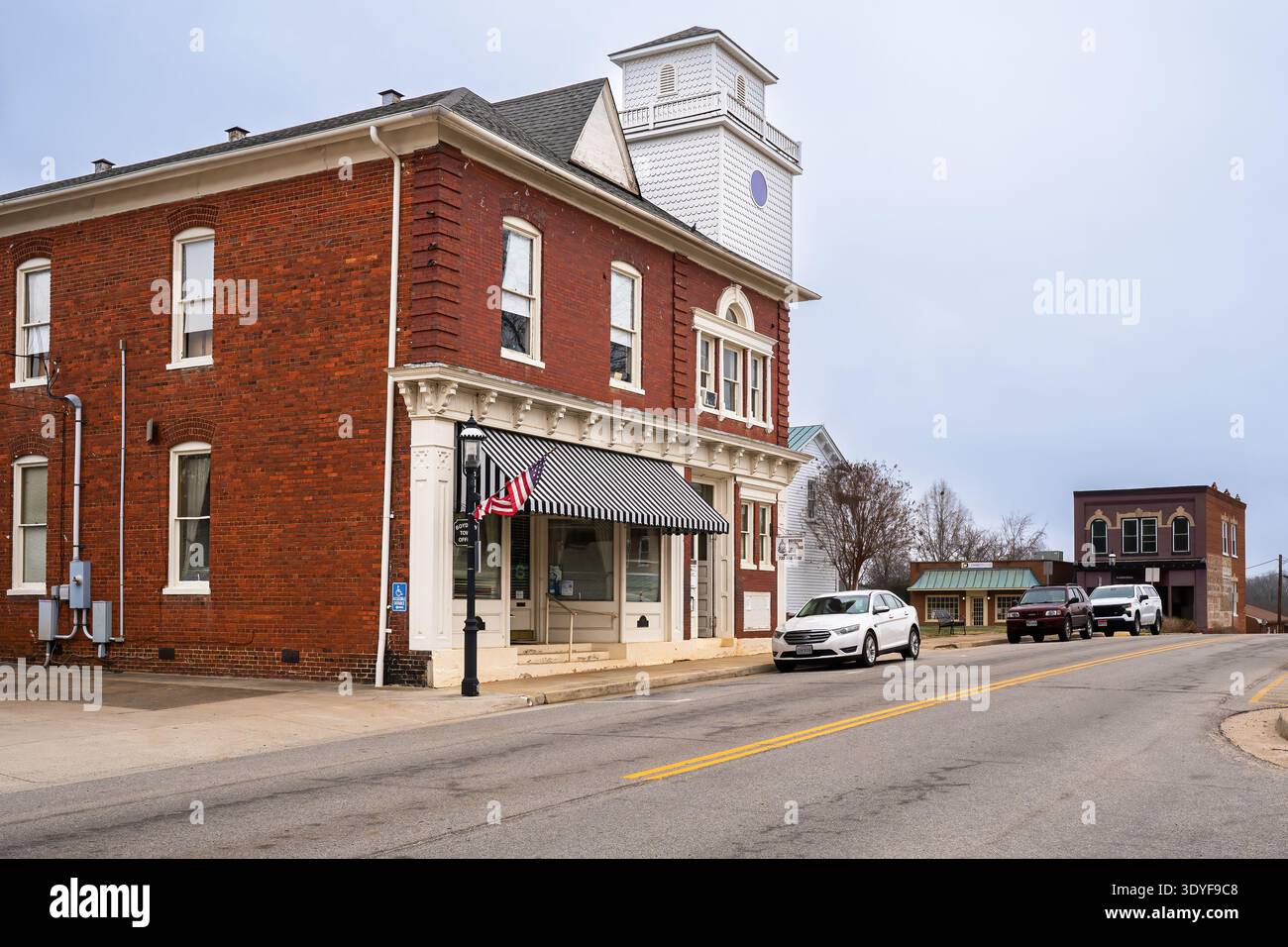 Boydton, Virginia, USA : Historic brick civic building with the Town of Boydton water tower rising behind it in the rural courthouse town. Stock Photo