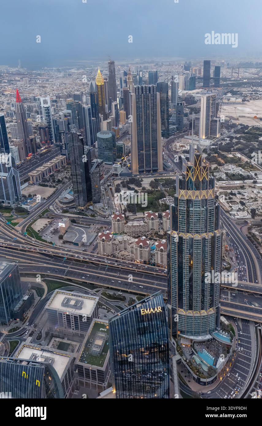 Regional financial pulse, dense skyscrapers and multilane highways spread across the central business district viewed from Burj Khalifa in Dubai, UAE. Stock Photo