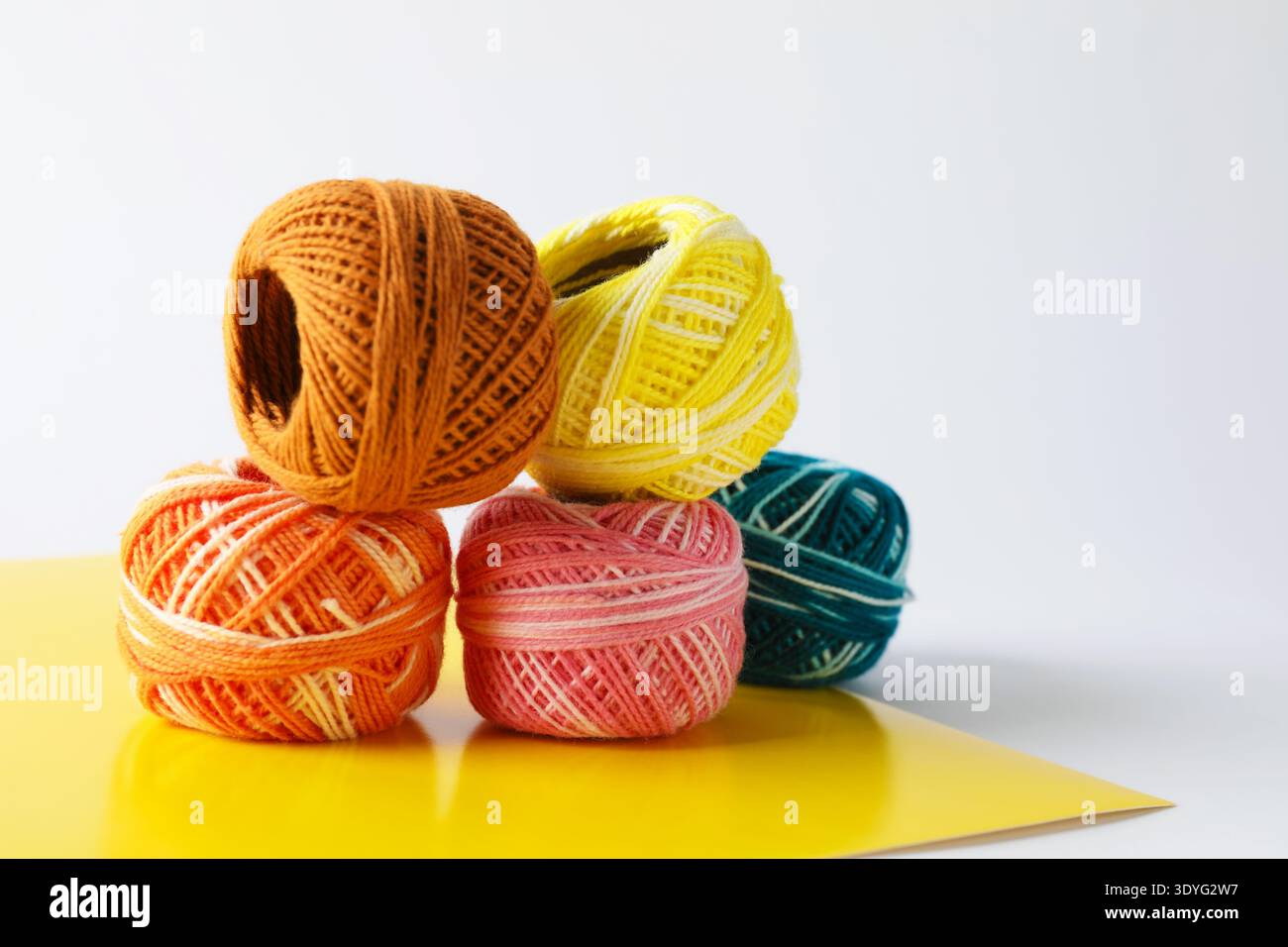 Many different spools of thread on light grey background, closeup Stock Photo