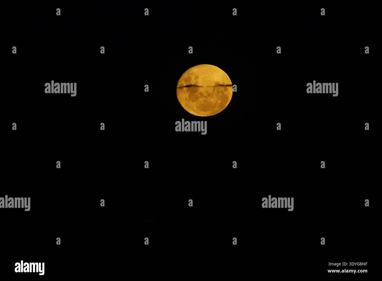 Blood moon during rising before eclipse in dark black sky background. Stock Photo
