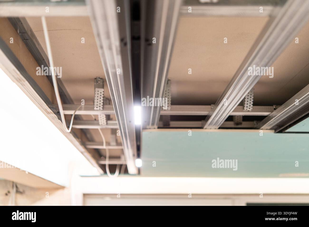 Close-up of a suspended ceiling framework showing metal rails and ...