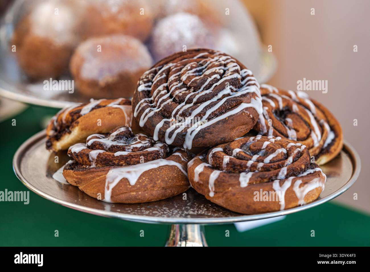 Close-up of a freshly baked cinnamon rolls with swirled layers of dough and cinnamon filling  on a tray Stock Photo