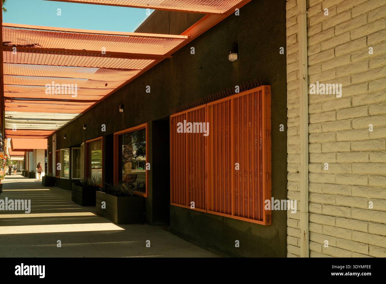 Slated Commercial Mid-century modern commercial building with orange slatted sun screens ...