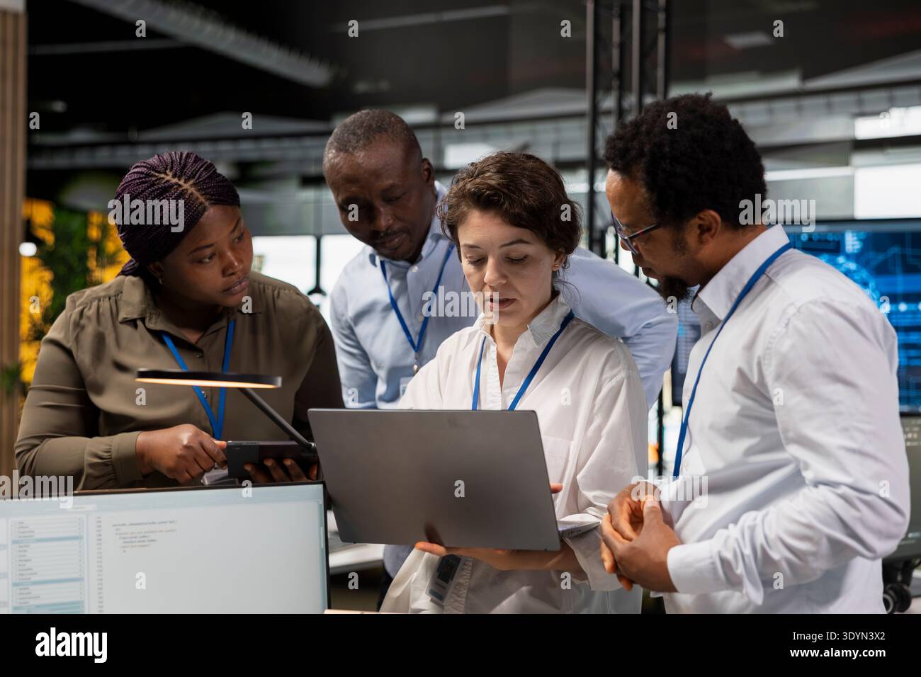 Engineering team in Silicon Valley company office developing software apps with laptop. Teamworking colleagues using notebook at work to code, debugging applications to resolve issues Stock Photo