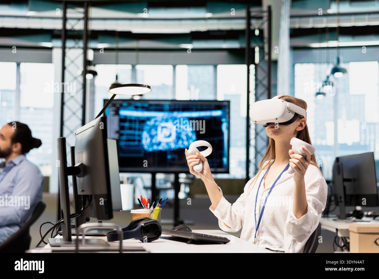 Female engineer using virtual reality tech adjusting deep learning algorithms parameters to automate tasks. Intern wearing VR headset working with AI driven insights on notebook for code optimization Stock Photo