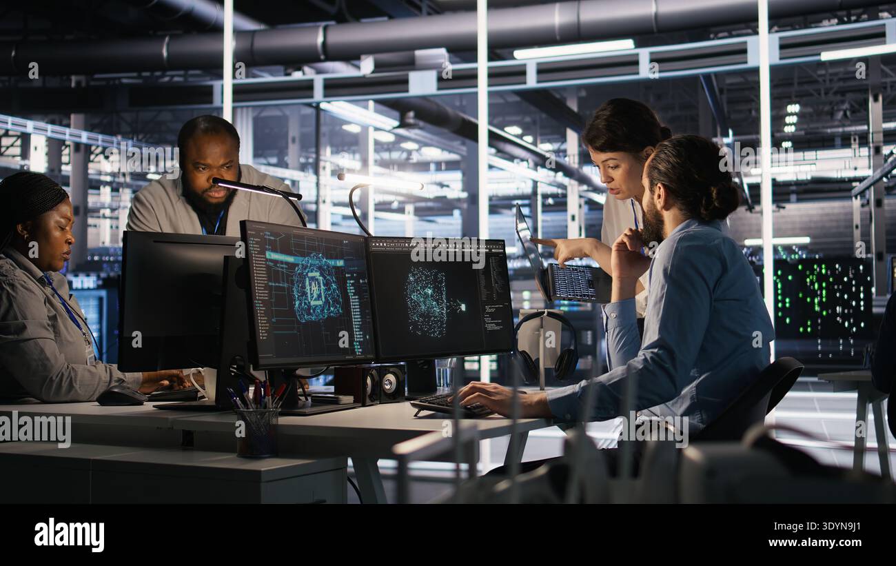 Data center admins working together, collaborating on neural network software development. Teamworking server hub colleagues implementing artificial intelligence technology in workplace, camera A Stock Photo