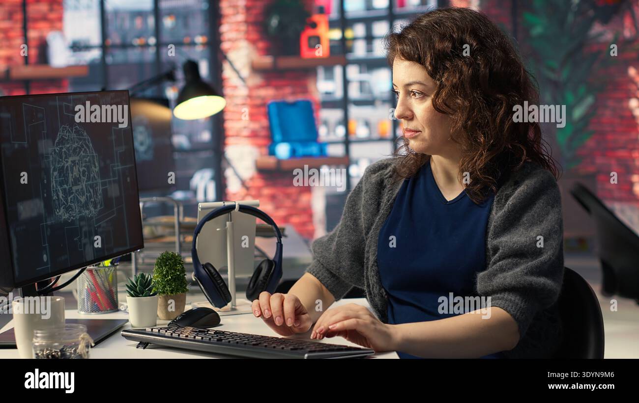 Teleworking developer using computer for artificial intelligence computing through self learning algorithms. Agency IT engineer works with AI deep neural networks on desktop PC. Camera B. Stock Photo