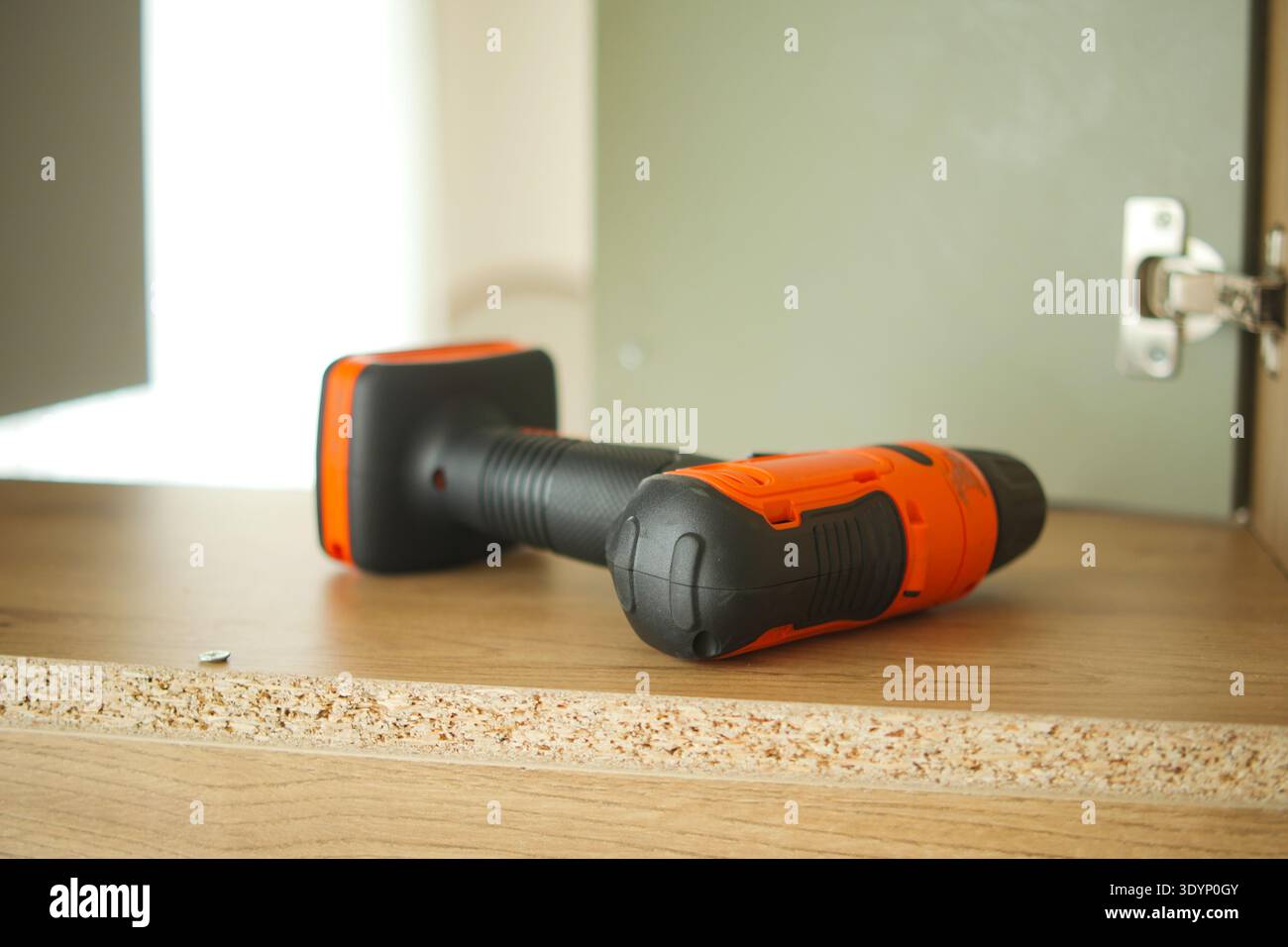 Electric drill on wooden surface in a workshop setting Stock Photo