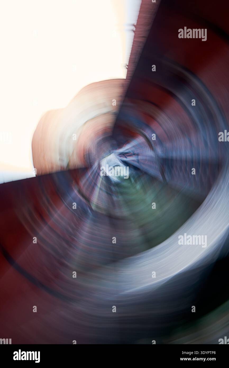 An energetic abstract background featuring a dynamic radial blur effect, creating a swirling vortex of vibrant colors. This modern digital art piece s Stock Photo