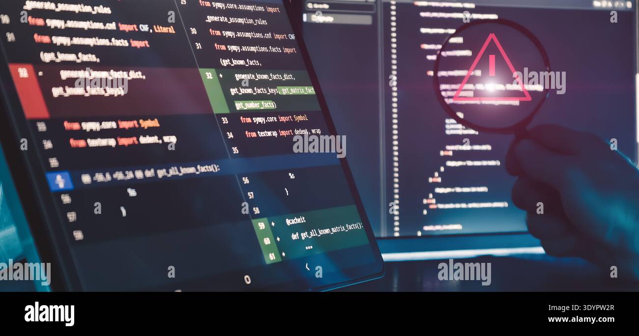 Code Error Detection and Software Debugging Concept with Warning Symbol in Magnifying Glass on Programming Stock Photo