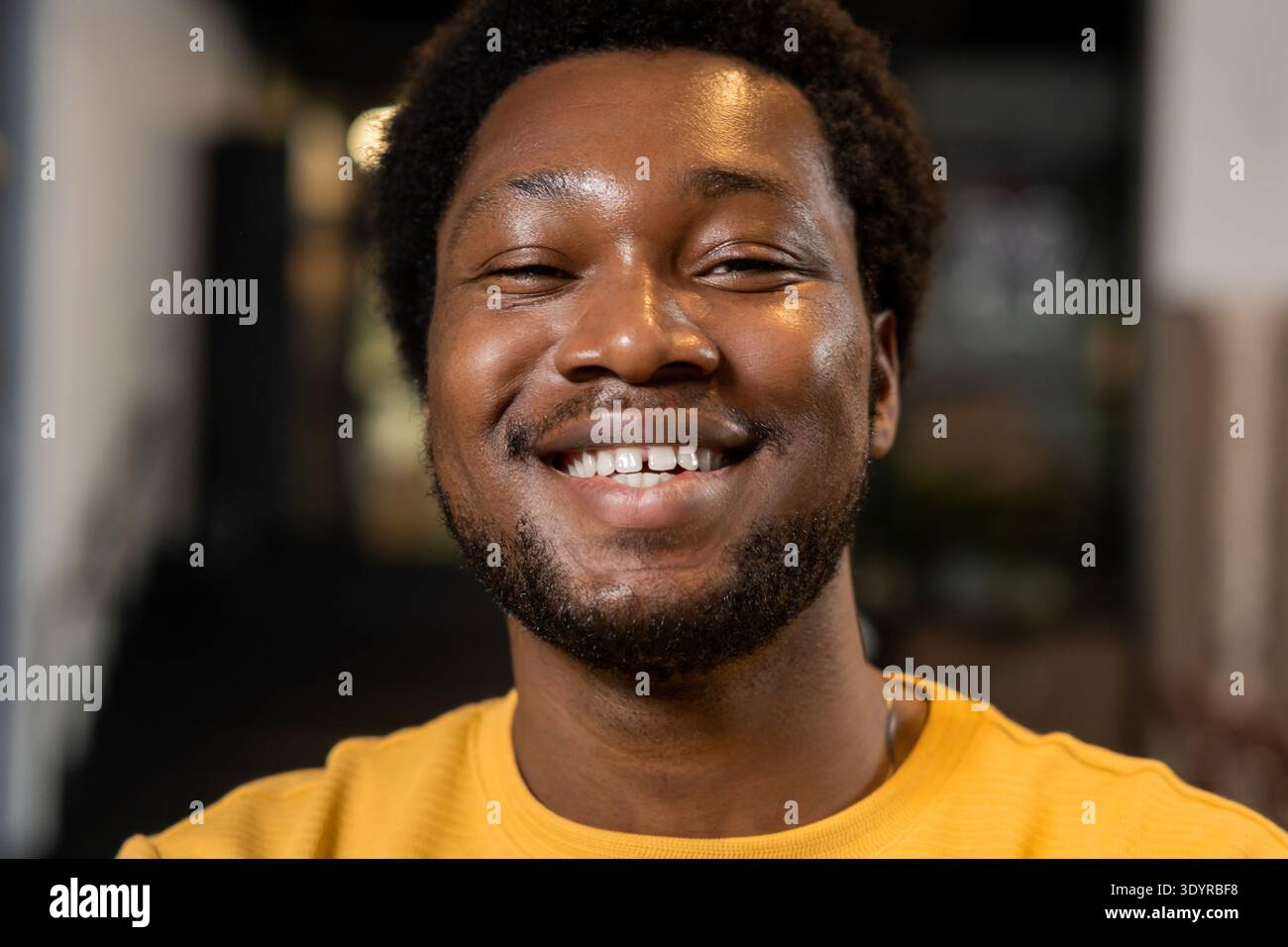 Young male close up portrait with friendly smile Stock Photo