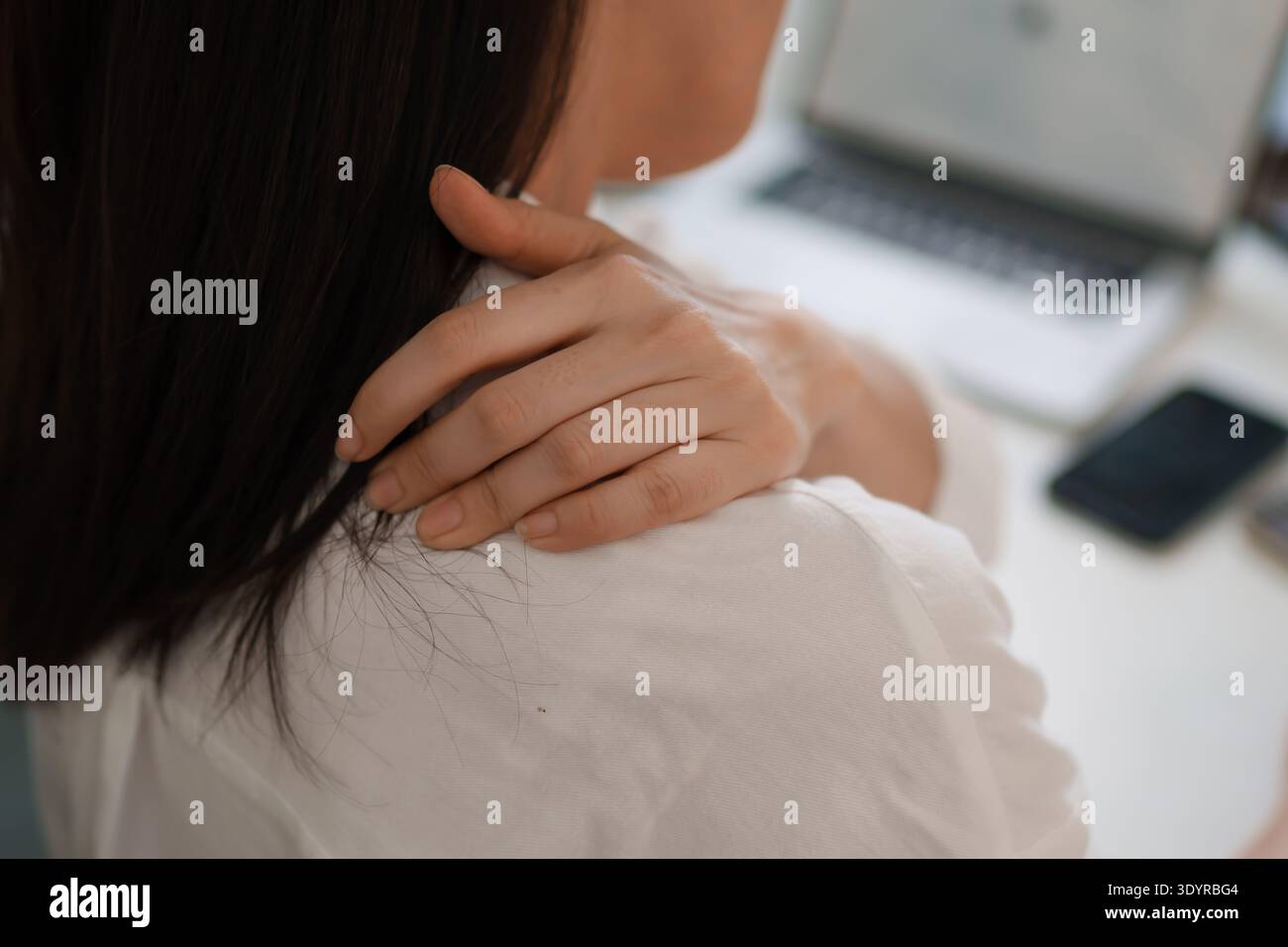Office worker neck and back pain from prolonged computer work Stock Photo