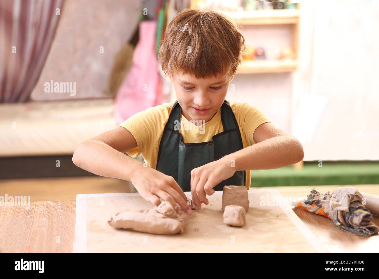 Kids molded from clay at pottery class. || Model released Stock Photo