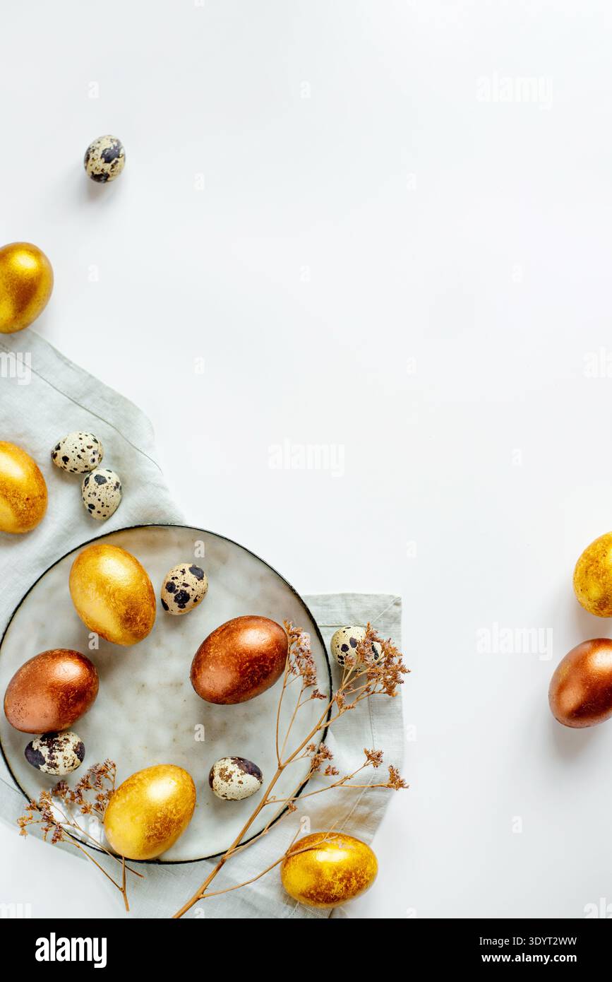 Golden and bronze Easter eggs in a grey plate Stock Photo