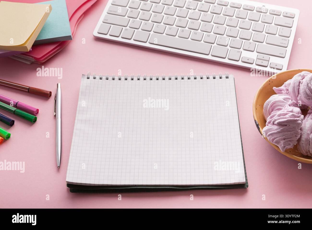 Spiral notepad on pink background Stock Photo