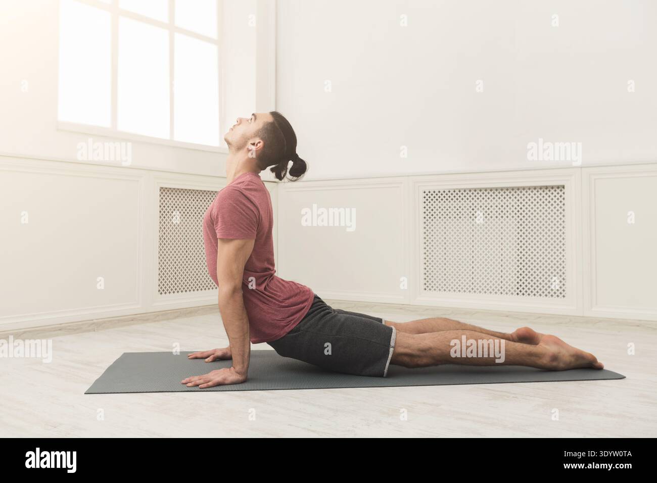 Man practicing yoga at gym Stock Photo