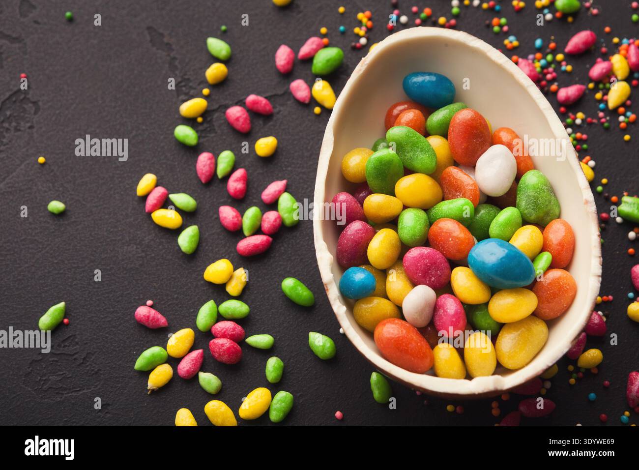 Chocolate egg and colorful candies Stock Photo