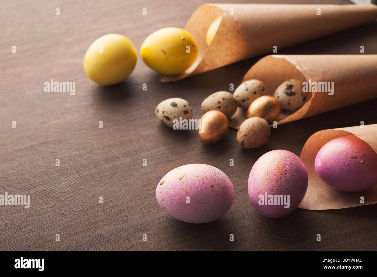 Easter composition with eggs in craft paper cornets Stock Photo