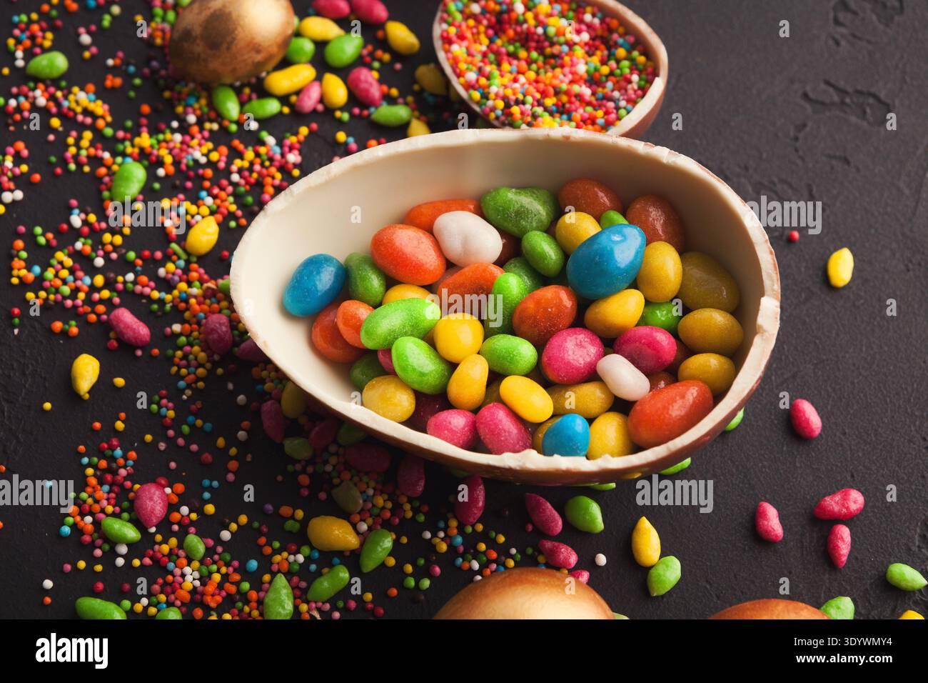 Chocolate egg and colorful candies Stock Photo