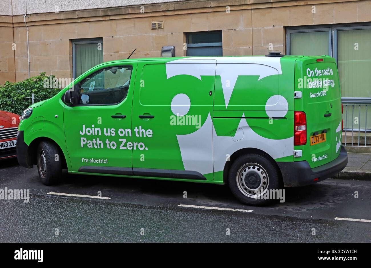 Green OVO Energy electric van in Scotland, branded “Join us on the Path to Zero” promoting cleaner energy and electric transport, UK. Stock Photo