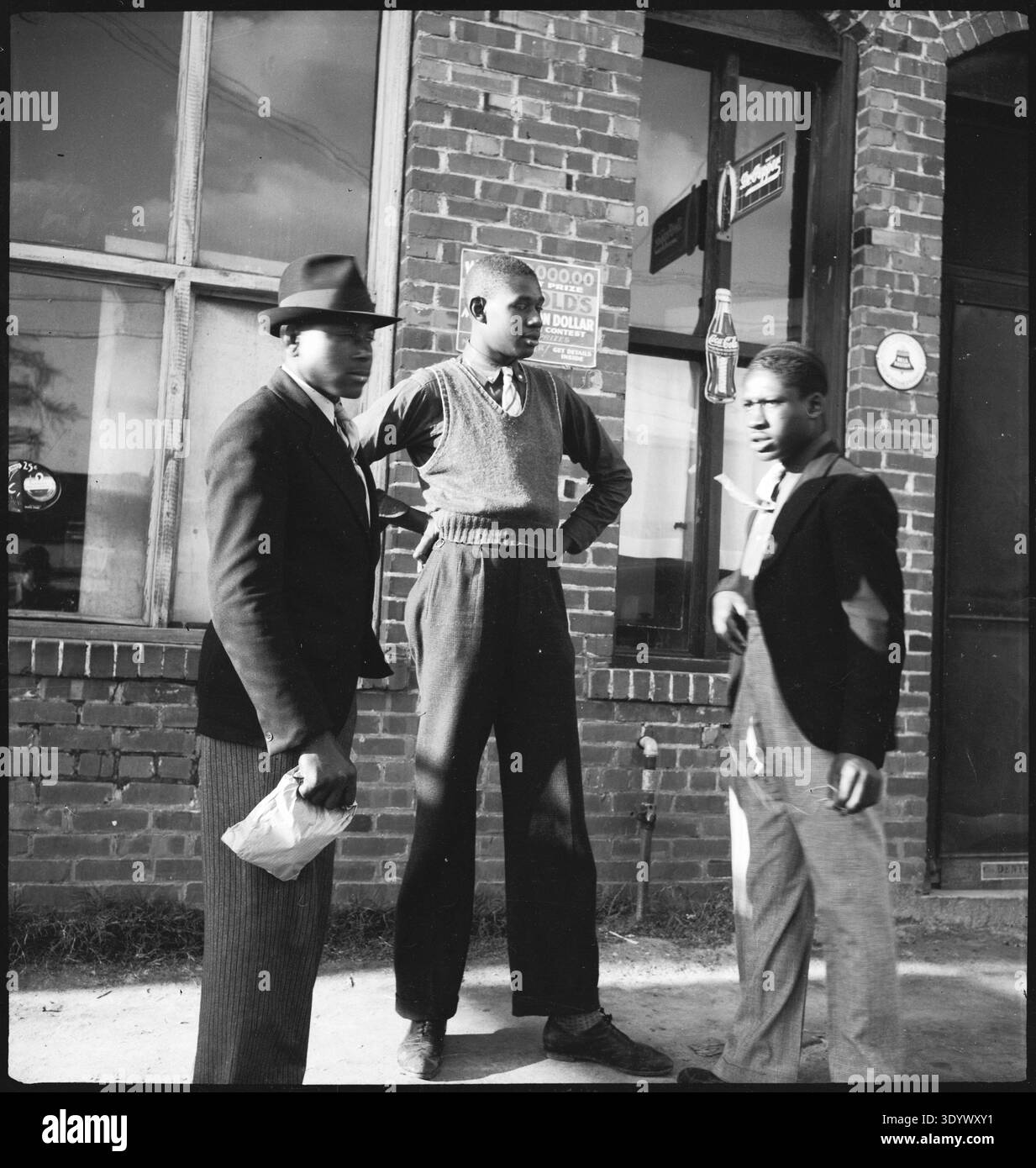 People: Three young men in conversation in front of a house Stock Photo ...