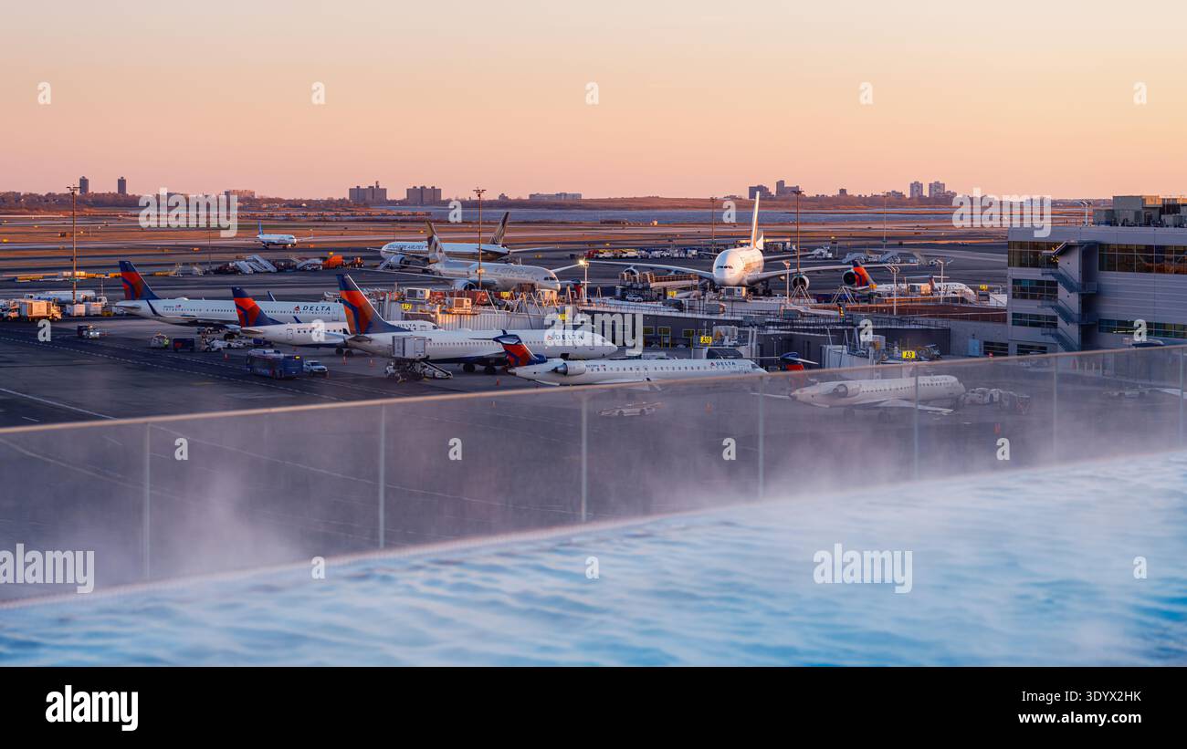 Twa Infinity Pool Golden hour view of Delta aircraft and airport apron activity at John F ...