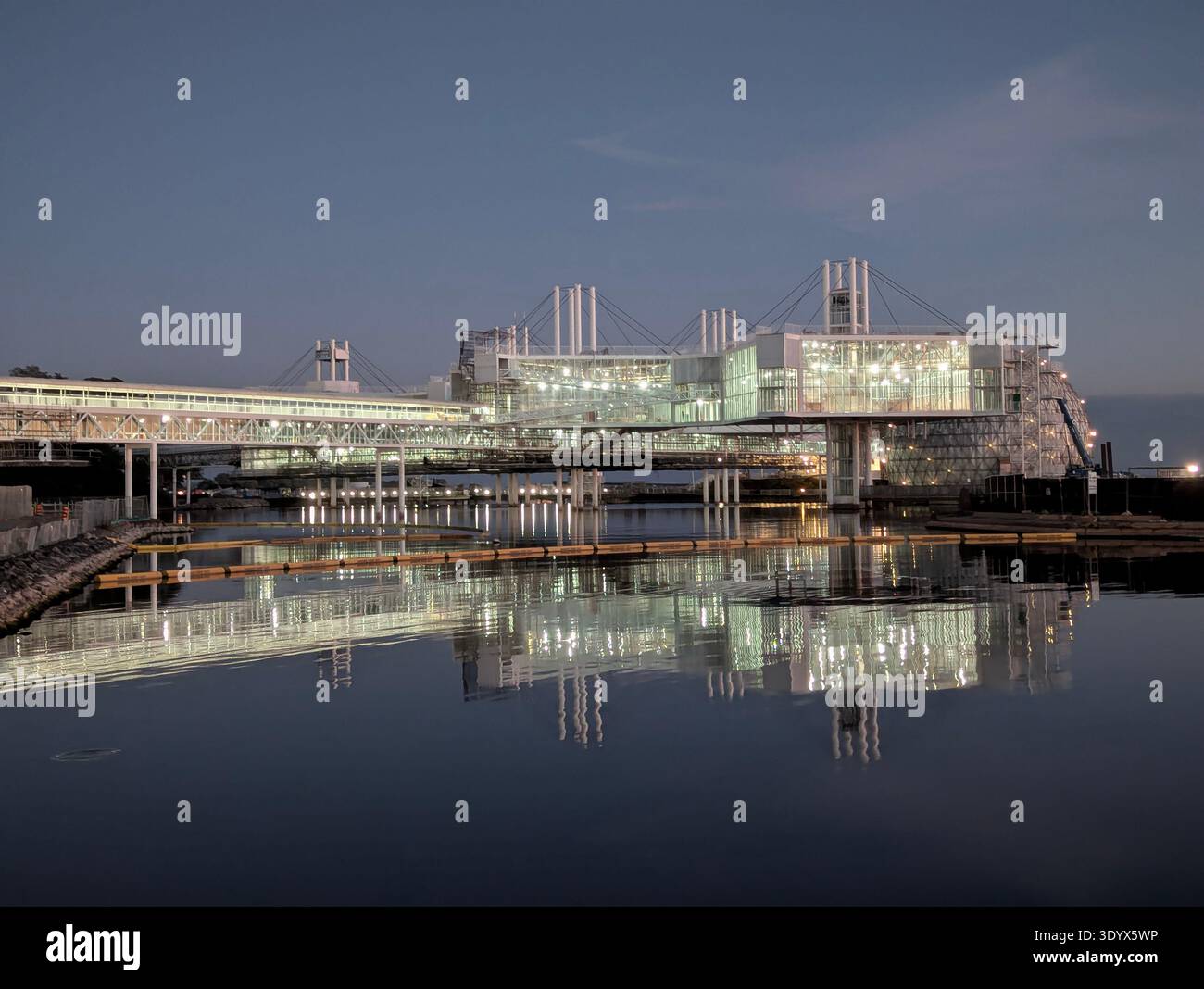 Iconic modernist architecture of Ontario Place pods at night, reflecting on the water at the Toronto waterfront, Ontario, Canada. - Smartphone Captured Stock Image
