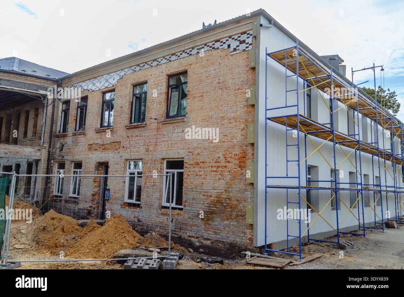 Renovation and repair of an old brick building with large blue metal ...