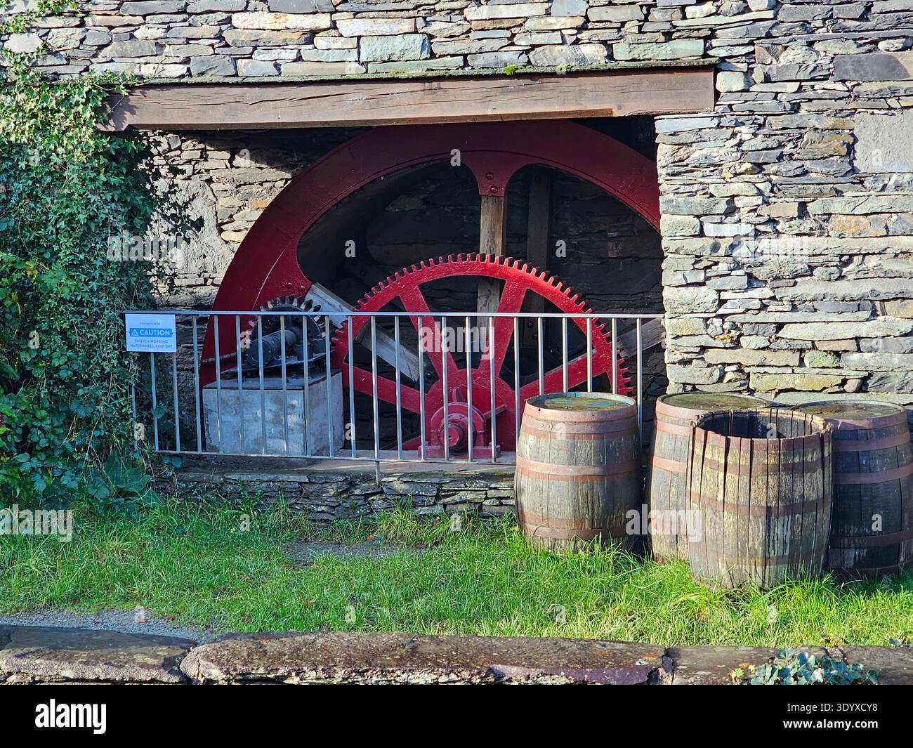 Restored mill wheel, Flying Fleece, Ambleside. Restored machinery of a former fulling mill on Stock Ghyll. - Smartphone Captured Stock Image