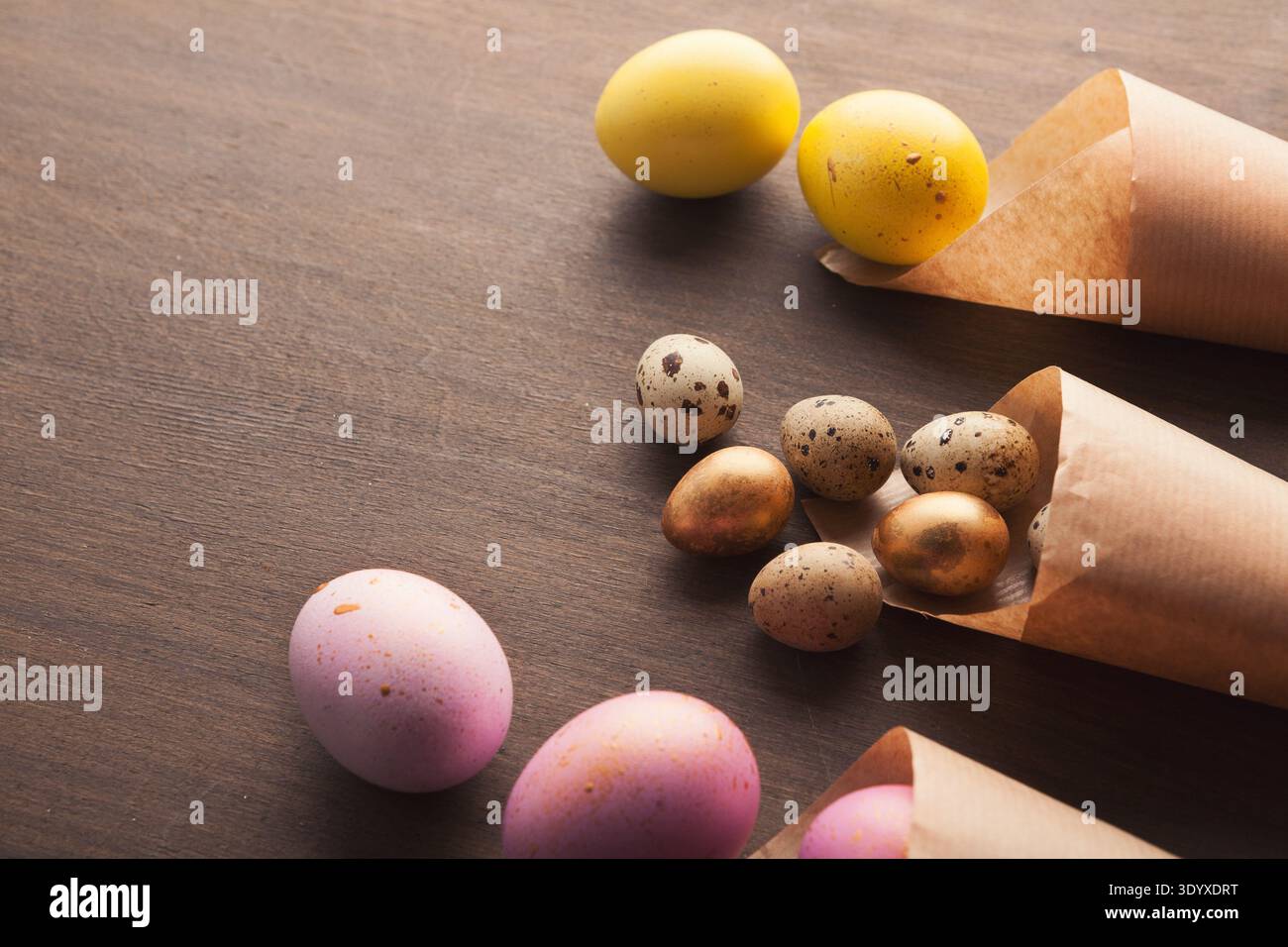 Easter composition with eggs in paper cornets Stock Photo