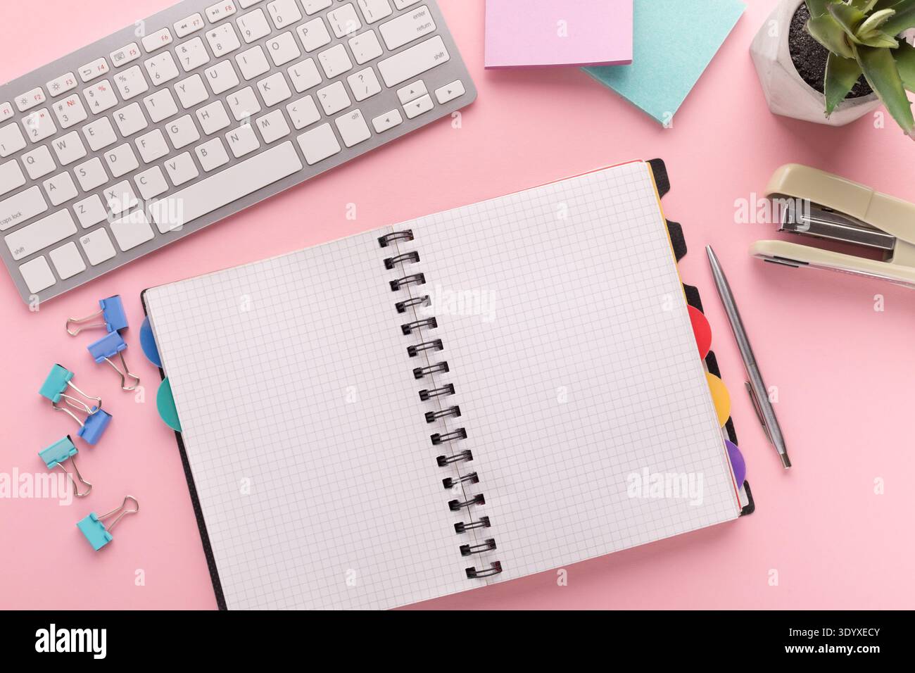 Spiral notepad on pink background, top view Stock Photo