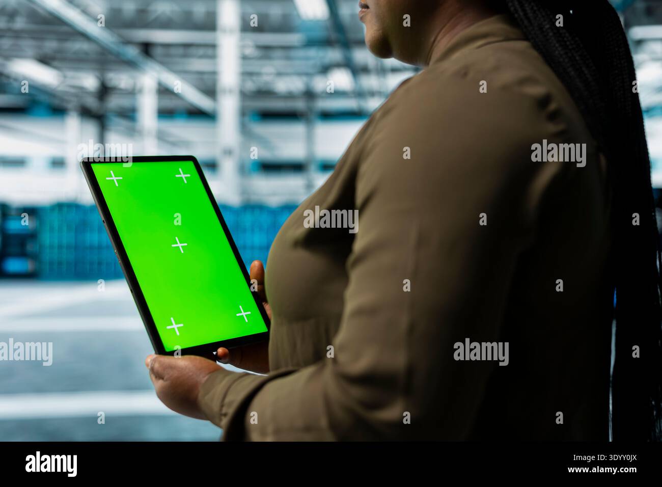 Data center software developer using green screen tablet to automate anomaly detection. Server hub IT professional using chroma key device, minimizing downtime through predictive maintenance Stock Photo