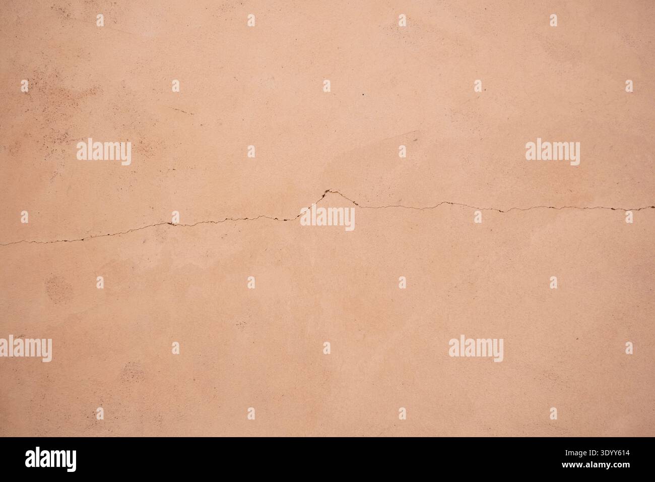 Terracotta wall texture with delicate crack, warm abstract background Description Stock Photo