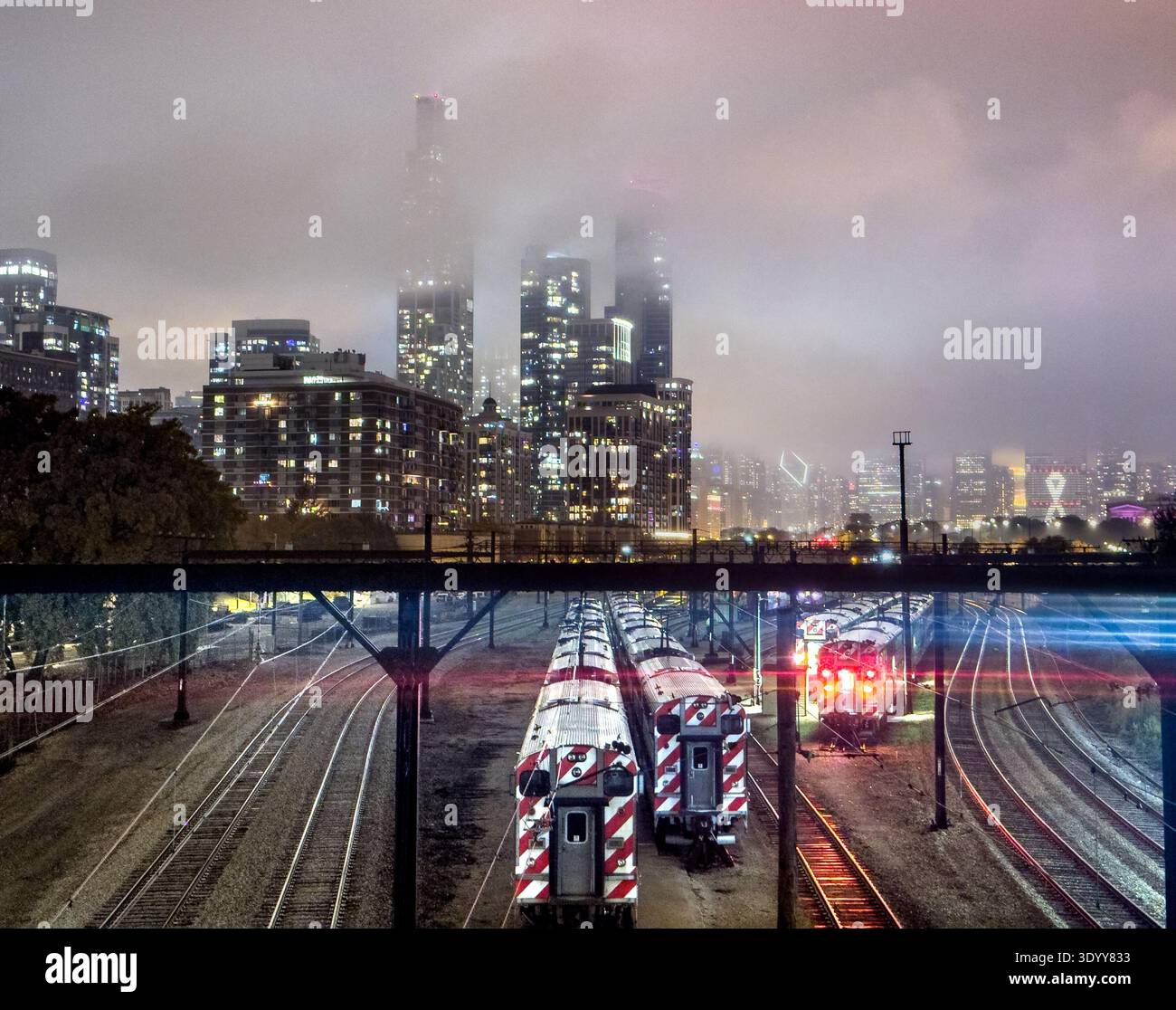 Train tracks at 18th street in downtown Chicago, Illinois, USA during a stormy, cloudy night - Smartphone Captured Stock Image