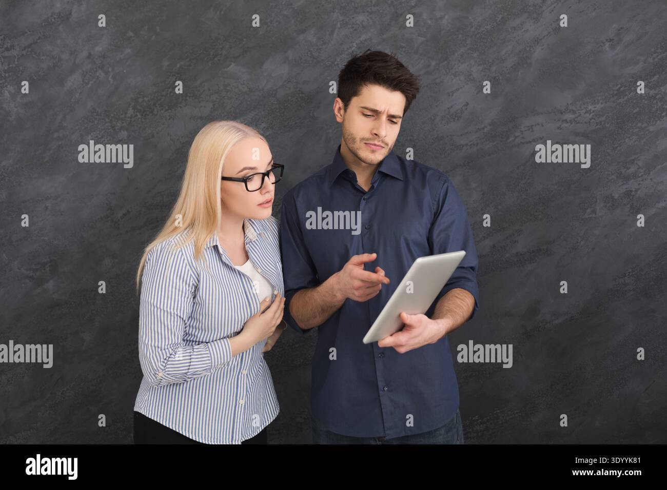 Serious couple using digital tablet at studio Stock Photo
