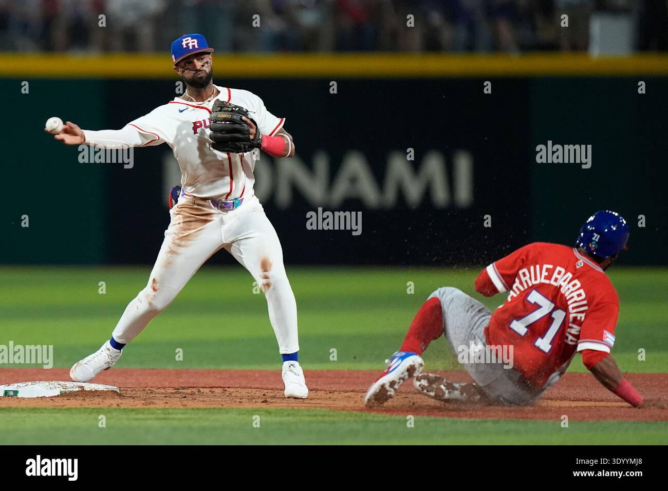 Puerto Rico's Darell Hernaiz, left, throws to first base after tagging ...