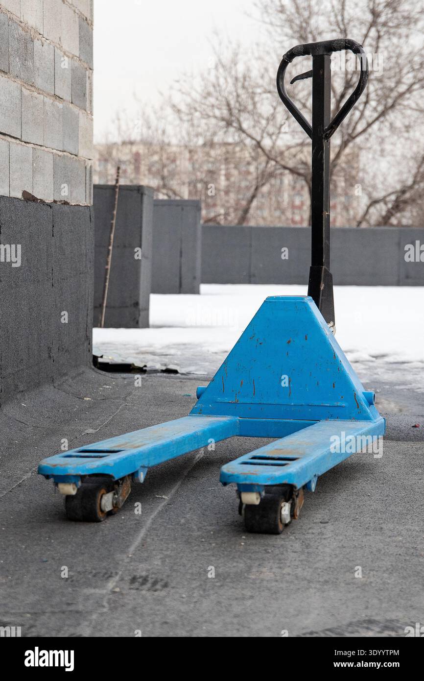 Blue pallet jack on a construction site rooftop Stock Photo